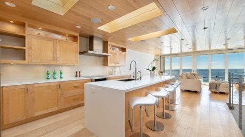 Contemporary family room and kitchen remodel with an ocean view by JRP Design and Remodel in Malibu