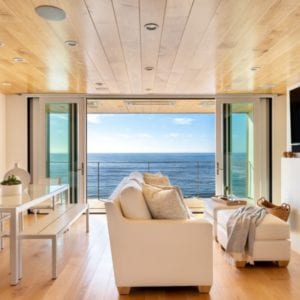 Contemporary family room remodel with an ocean view by JRP Design and Remodel in Malibu