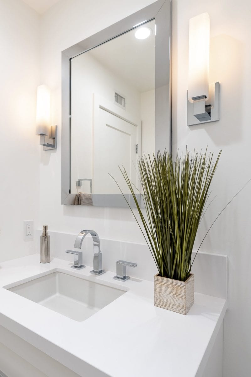 Feature photo of minimal all white bathroom renovation by JRP Design and Remodel in Westlake Village