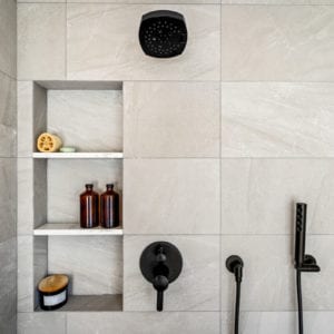 Master bathroom large grey tiled shower with black matte fixtures in Camarillo by JRP Design and Remodel