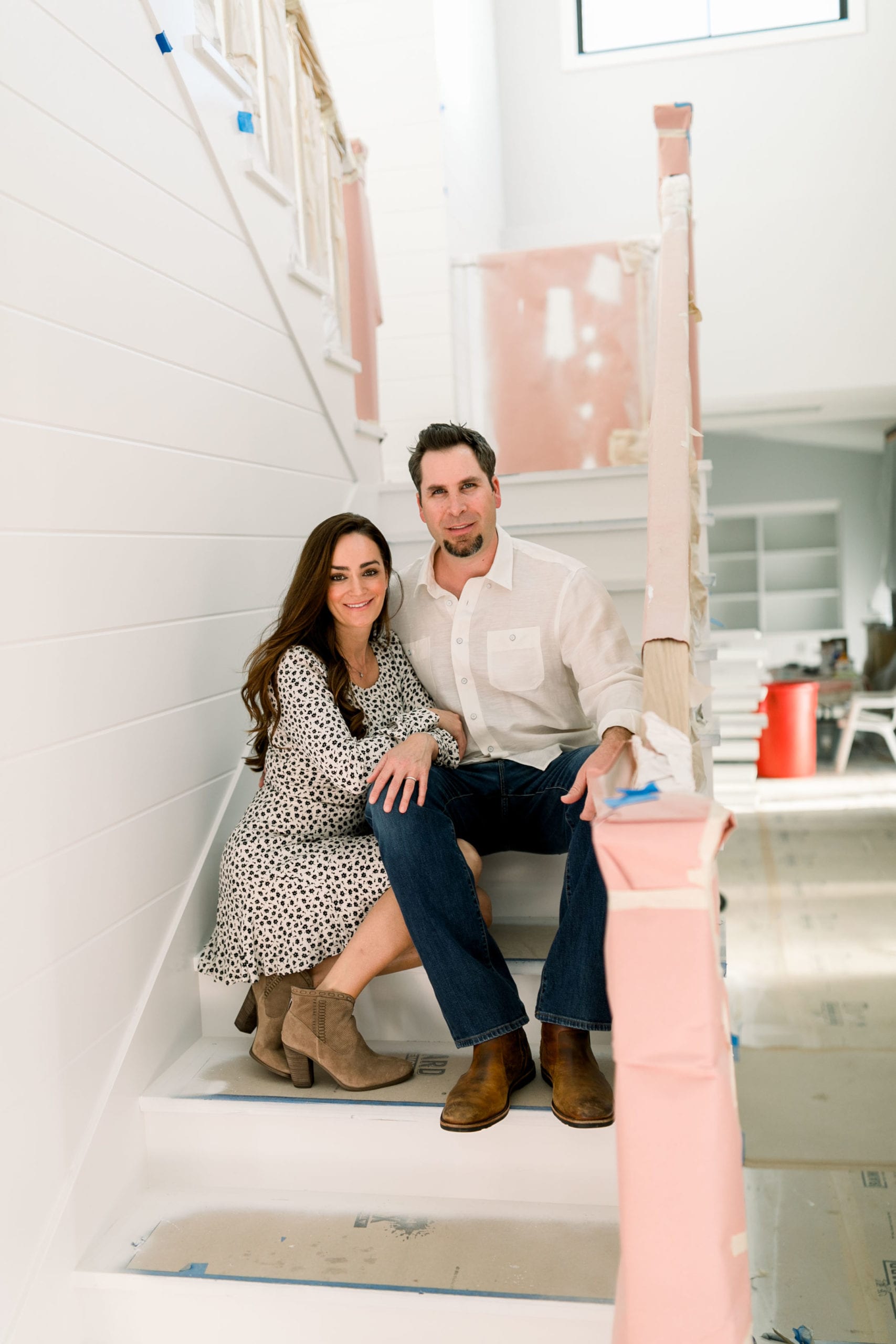 Lori and Justin on stairs in a project currently under construction 2020 our story