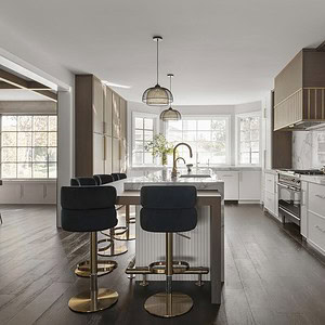 Modern kitchen with an island featuring dark chairs, gold fixtures, white cabinetry, stainless steel appliances, and a light-filled bay window seating area exuding sophisticated glamour.