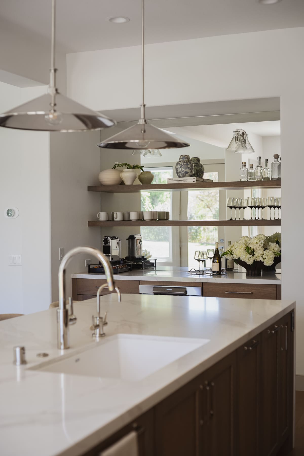 Perfectly Polished Kitchen remodel featuring a large island, modern coffee bar, sleek cabinetry and polished nickel accents, by JRP Design and Remodel.
