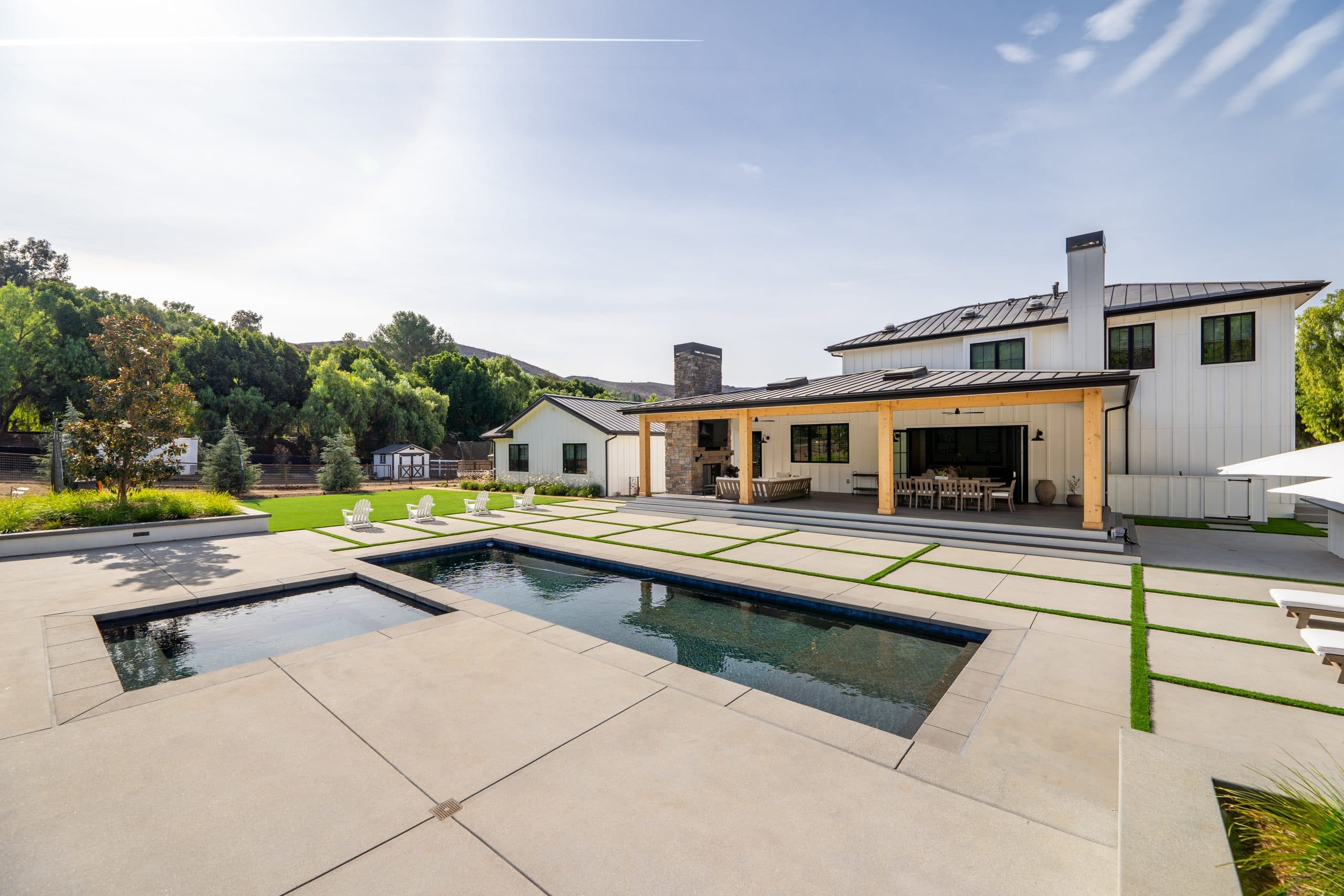 Beautiful backyard with pool, patio, and modern farmhouse design elements.