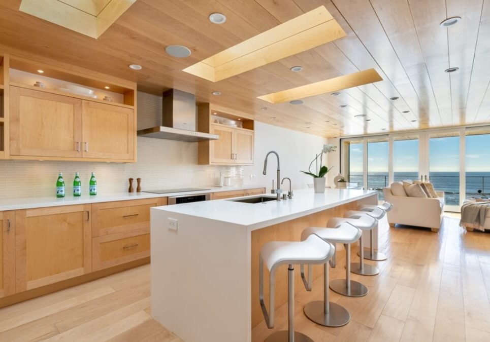 Contemporary family room and kitchen remodel with an ocean view by JRP Design and Remodel in Malibu